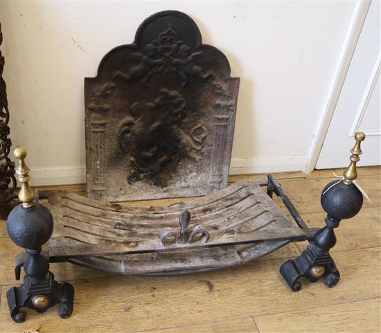 A pair of fire dogs and a cast iron fireback Fire basket W.90cm Fireback W.50cm